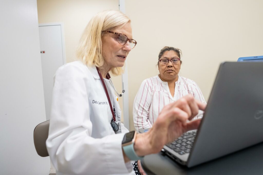 Maria, a patient at the Bob Macauley Americares Free Clinic of Norwalk, benefits from multiple health programs at AFC, including health coaching. With lifestyle changes and medication adherence to address diabetes and hypertension, Maria now enjoys general well-being. Maria is shown here with Americares Free Clinics Director of Medical Services, Debra Gerson, M.D. July 3, 2024. (Photo/Andrea Pane)